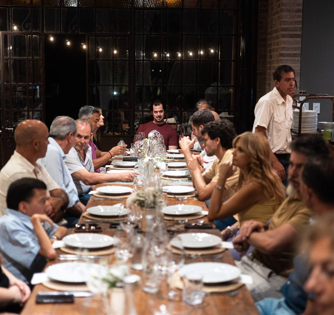 Dinner table gathered under string lights with the Miner Wine Club